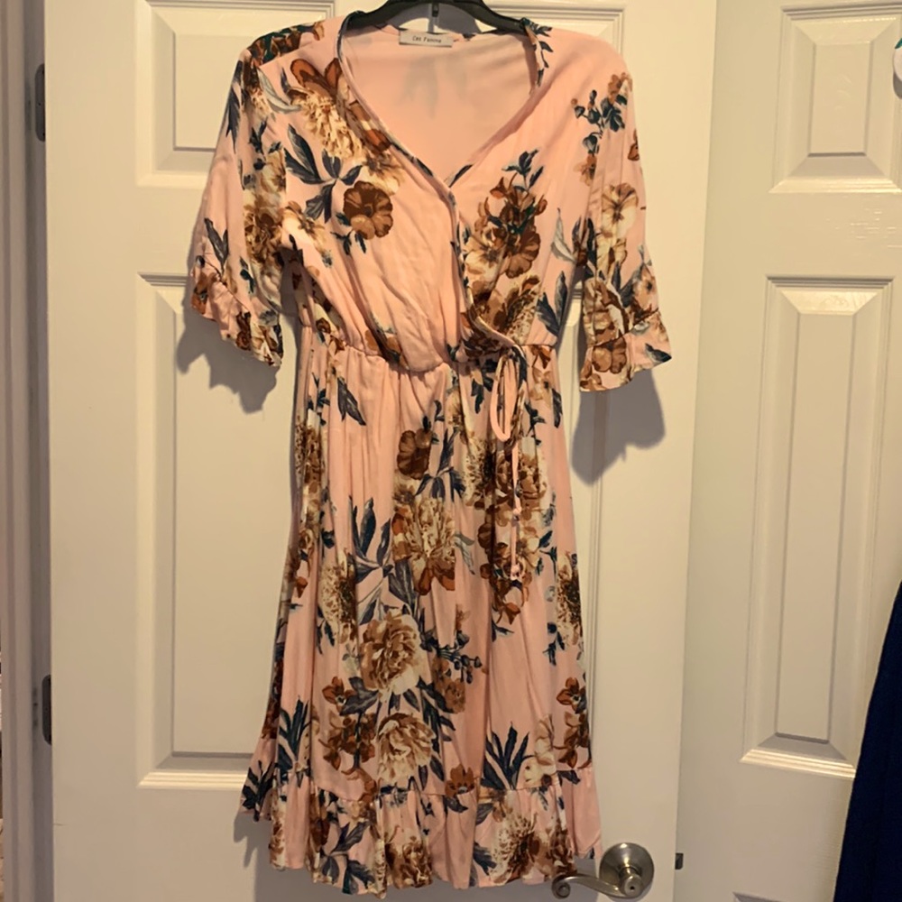Fun boutique style pink dress with flowers.